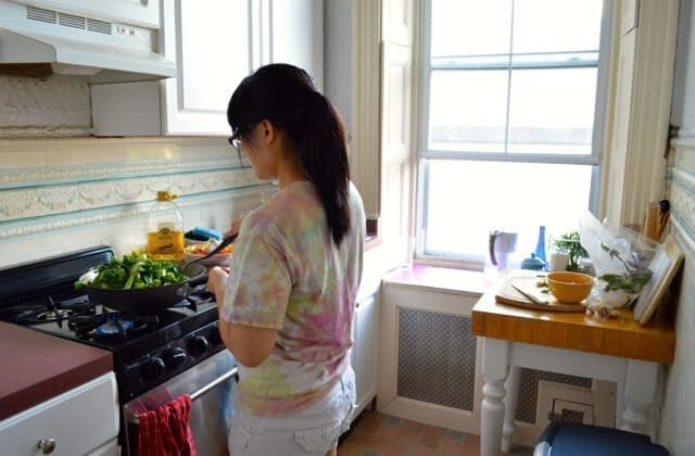Kaitlin cooking in apartment kitchen