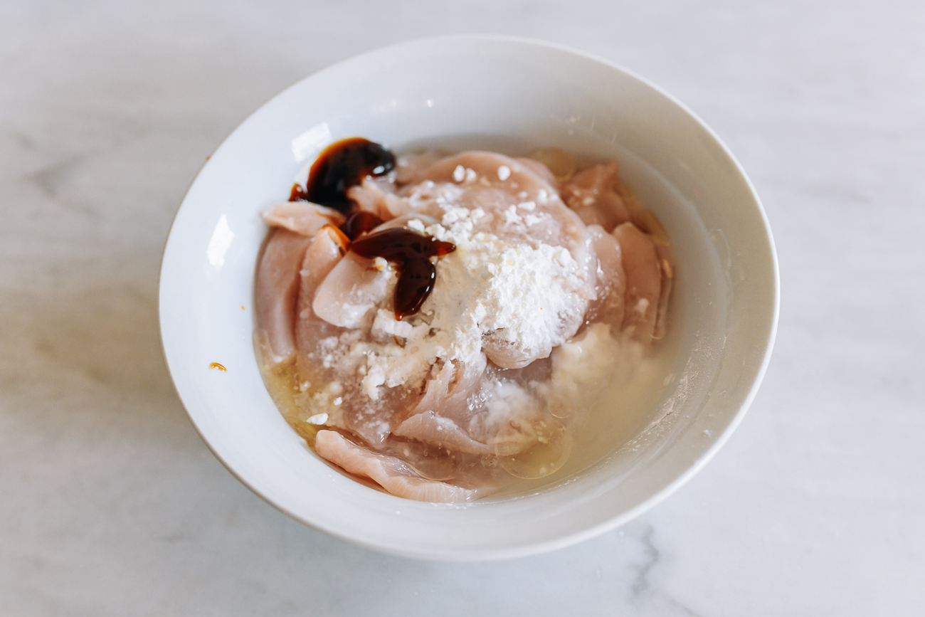 Sliced chicken with marinade ingredients added