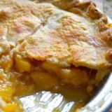 Peach pie with slice taken out