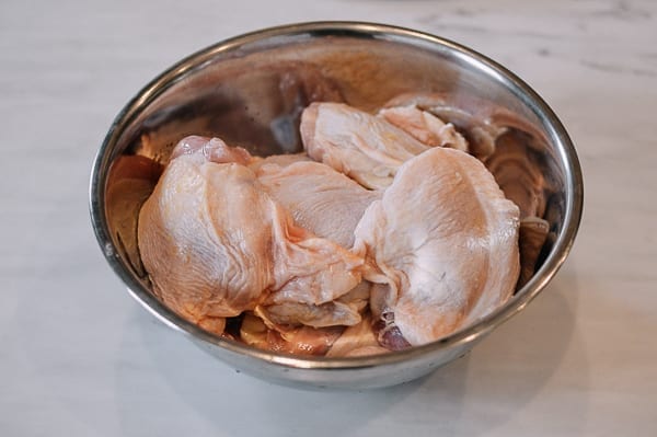 Adding chicken to the marinade bowl, thewoksoflife.com