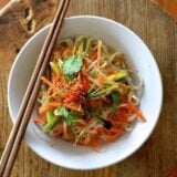 Bowl of noodles with julienned vegetables and chopsticks