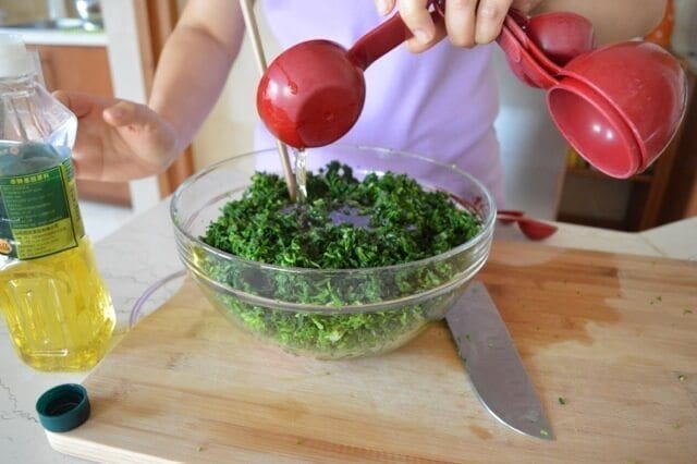 adding oil to dumpling filling