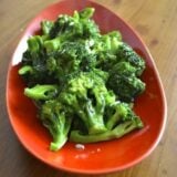 Stir-fried broccoli with garlic in red bowl