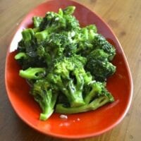 Stir-fried broccoli with garlic in red bowl