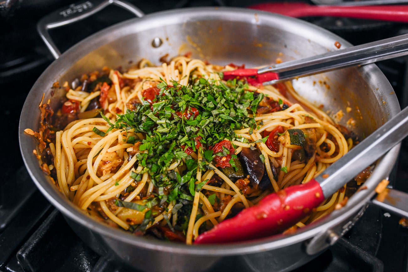 chopped fresh herbs on ratatouille pasta