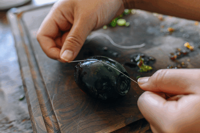 slicing century egg with thread