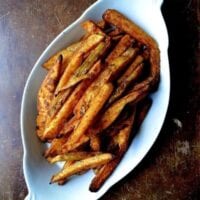 Baked french fries in white gratin dish