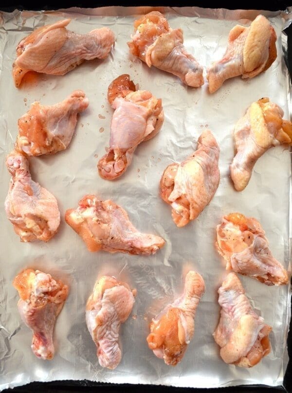 Chicken drumettes on foil lined baking sheet