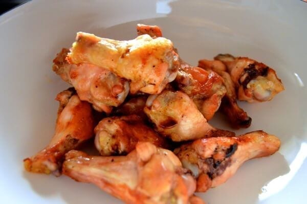 Roasted chicken wings in mixing bowl