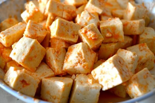 Firm tofu cubes coated in Sriracha and Honey by thewoksoflife.com