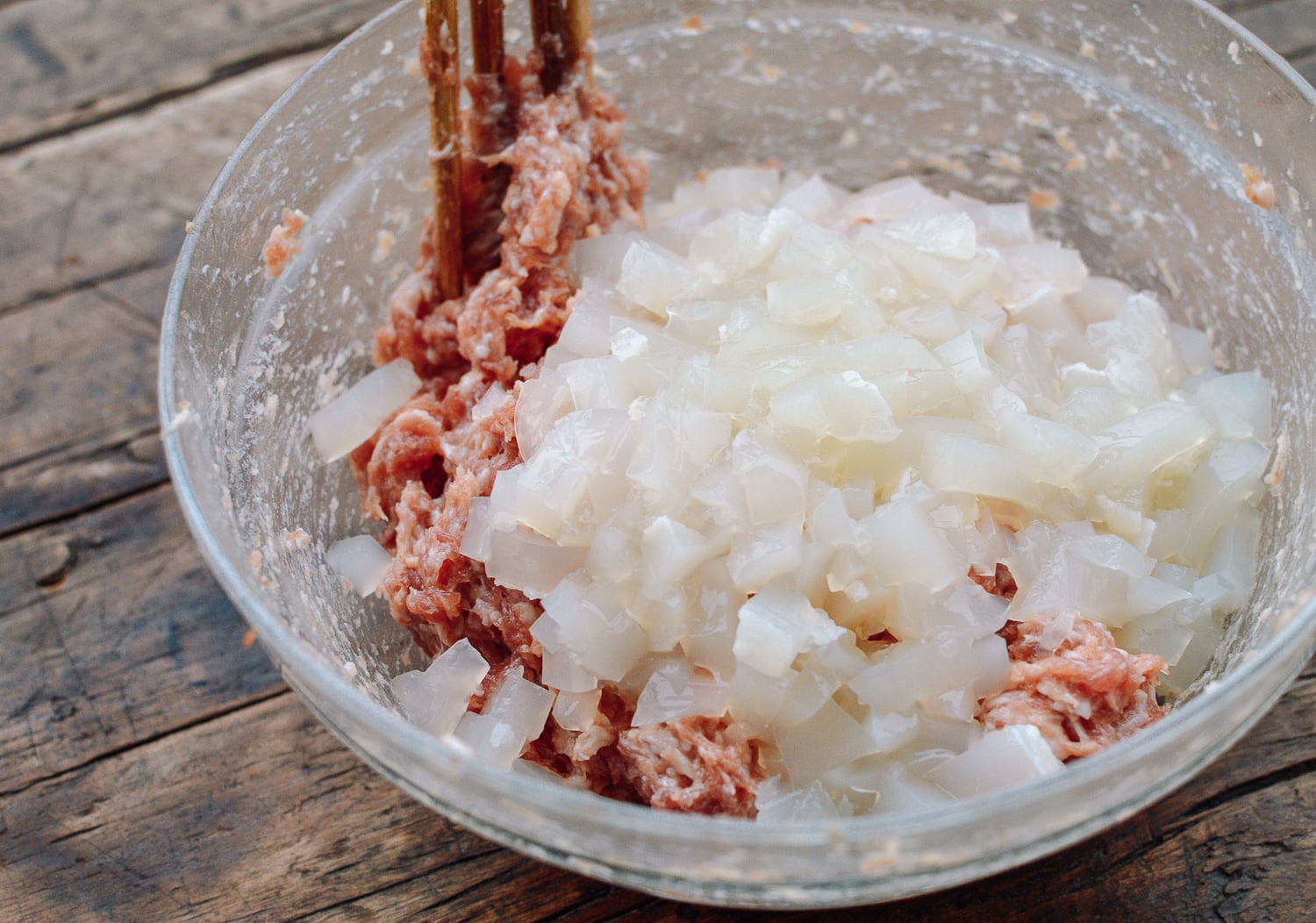 Mixing pork and aspic to make filling, by thewoksoflife.com