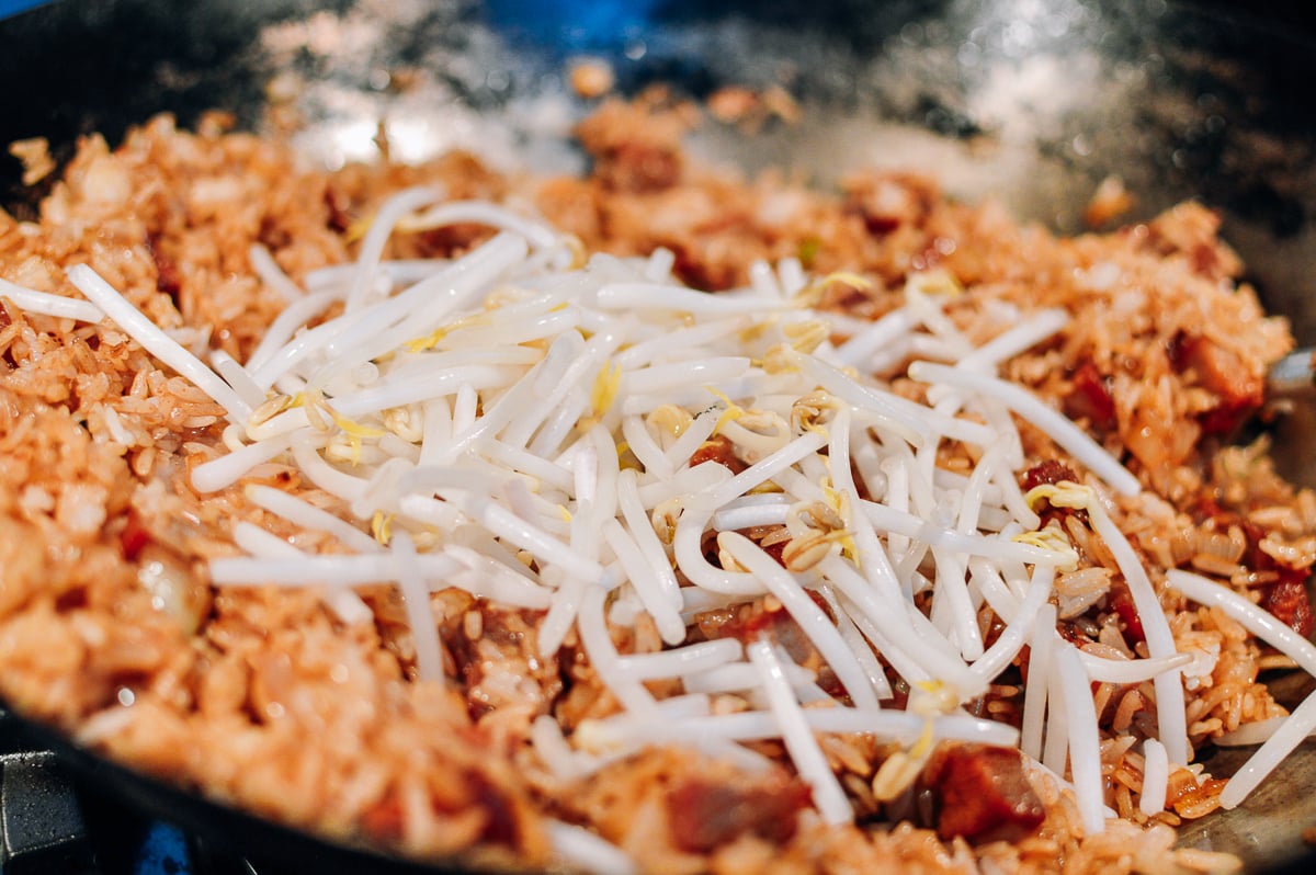 Adding mung bean sprouts to fried rice, by thewoksoflife.com