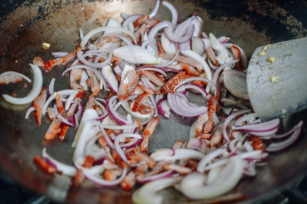 stir-frying onions and char siu