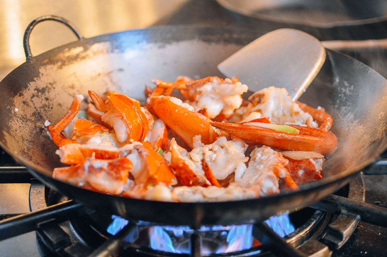 cooking lobster pieces in wok