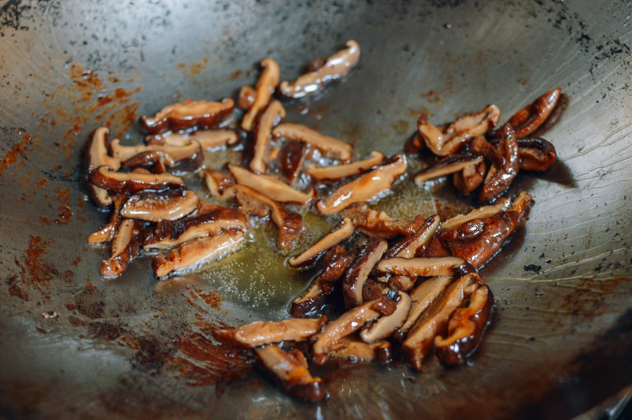 searing mushrooms in wok
