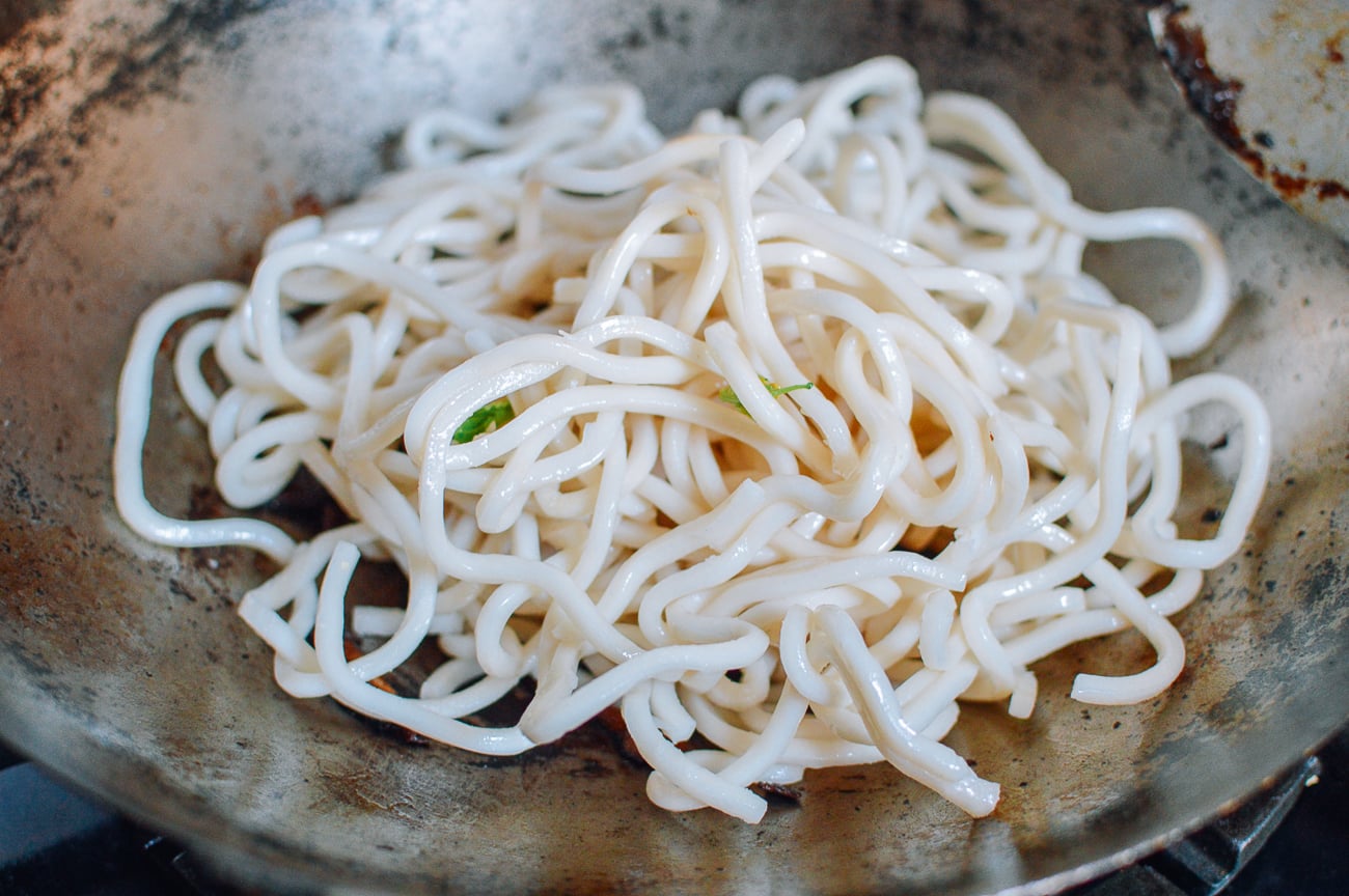 udon noodles in wok