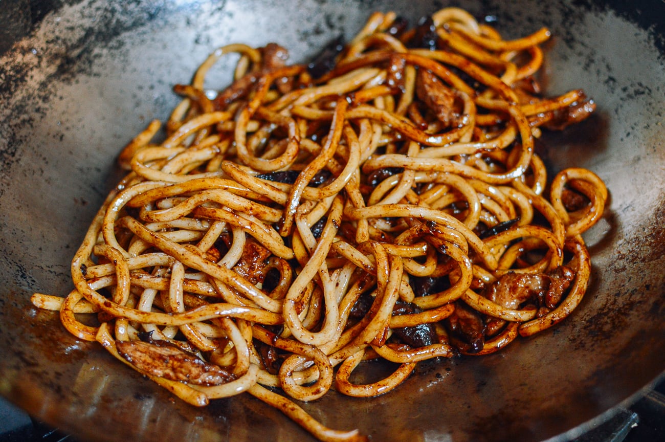sauced udon noodles in wok