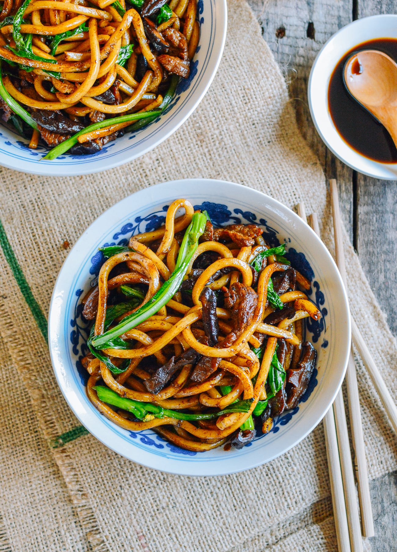 Shanghai fried noodles with mushrooms, pork, and leafy greens