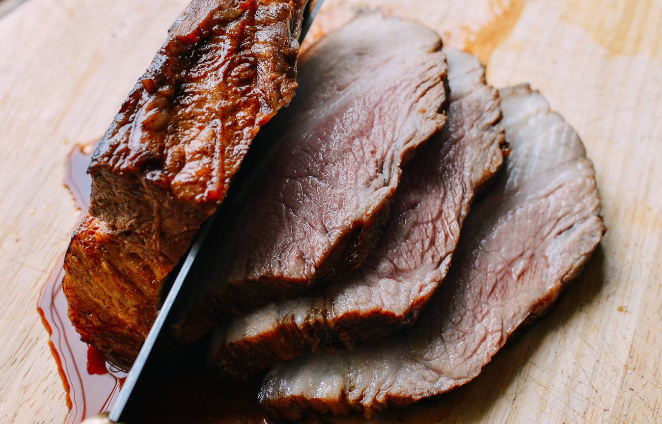 Slicing par-cooked pork belly