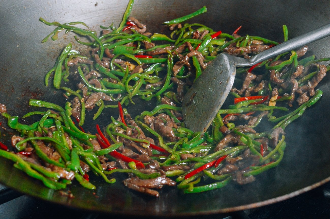 stir-frying beef and peppers