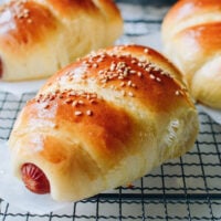 Chinese hot dog buns on cooling rack