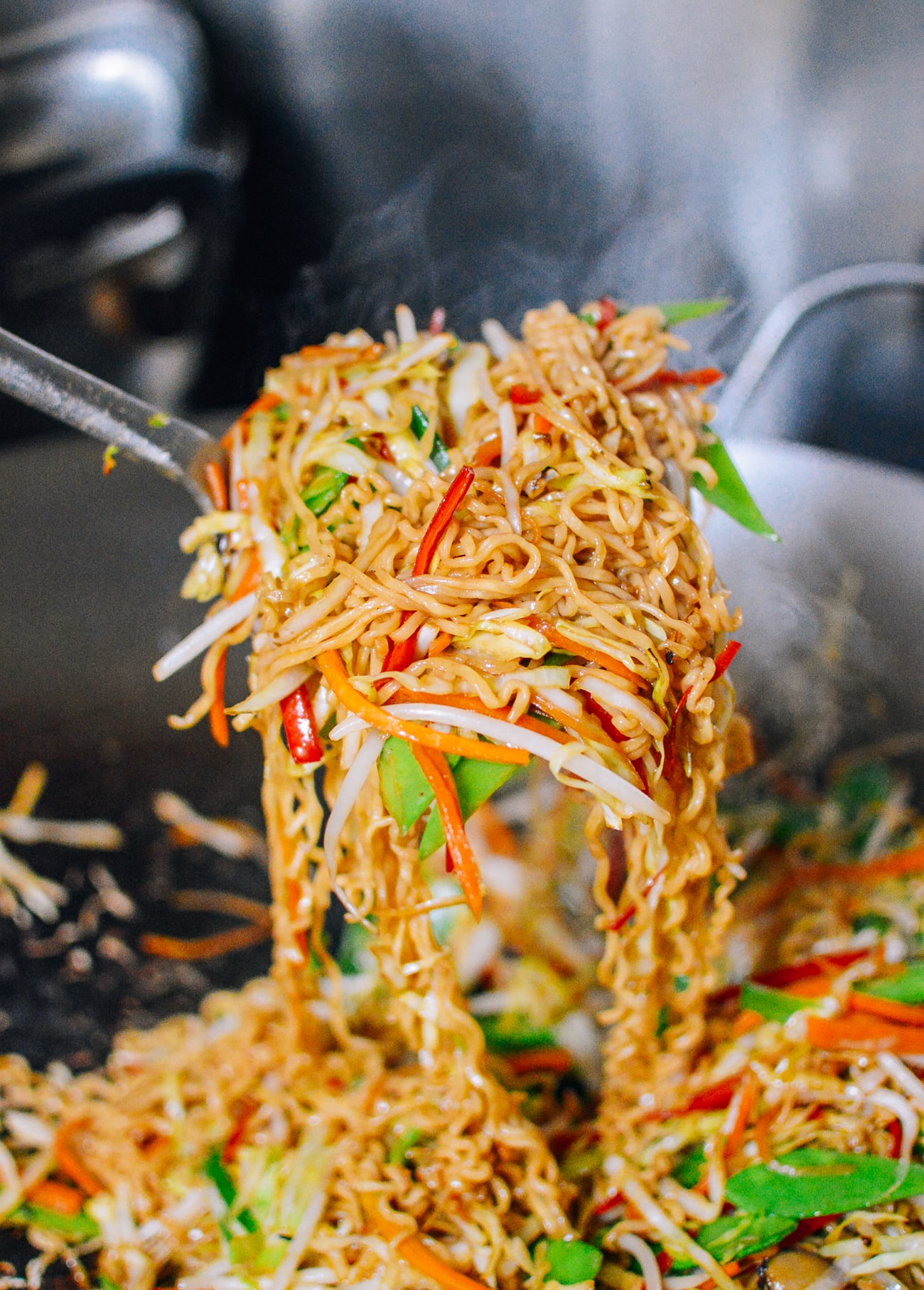 Picking up vegetable ramen noodle stir-fry