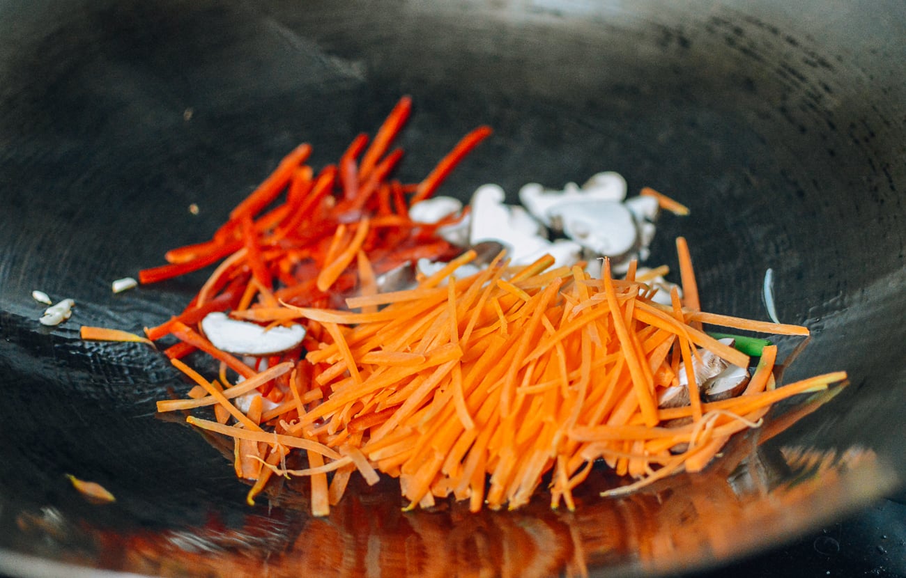 mushrooms, peppers, and carrots in wok