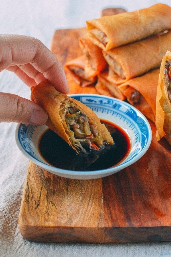 Dipping spring roll in sauce, thewoksoflife.com
