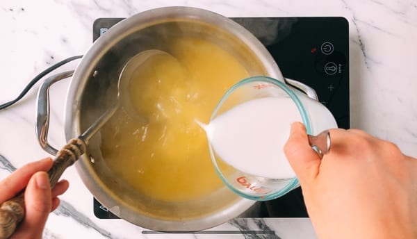 Adding cornstarch slurry to thicken soup, thewoksoflife.com