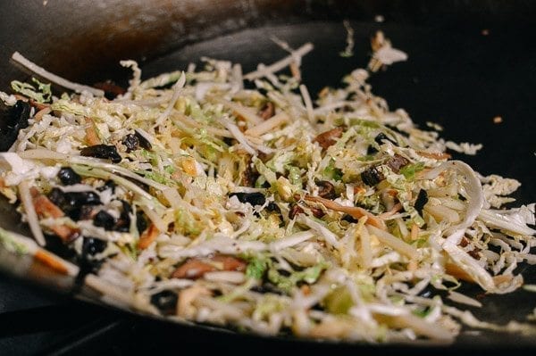 Stir-frying shredded cabbage, mushrooms, and lily flowers for moo shu by thewoksoflife.com