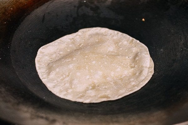 Cooking Mandarin Pancakes in wok, by thewoksoflife.com