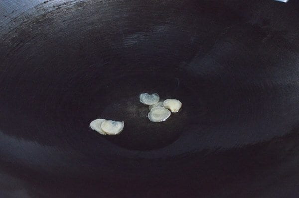 Sliced ginger infusing oil, thewoksoflife.com