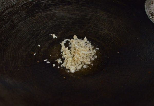 Take the shrimp and noodles out of the refrigerator, and let them come up to room temperature. One trick for the noodles is to soak the whole bag (unopened) in hot water, which speeds up the warming process without making the noodles soggy. If you can’t find lo mein noodles, you can actually substitute dried linguini. Just cook until al dente, drain, and immediately toss with 1 tablespoon of vegetable oil, working the oil into the pasta so the noodles don't stick together. Always prepare your noodles just before you are ready to make the dish, so they don’t dry out and remain at room temperature or warmer. This makes the stir-frying process much easier. Combine the sugar, soy sauces, oyster sauce, sesame oil, and white pepper in a bowl until the sugar is dissolved and set aside. Heat a large wok over high heat until it just starts to smoke, and add 1 tablespoon of oil around the perimeter of the wok. Quickly spread the shrimp around your wok and let them sear for 10-15 seconds on each side. Immediately transfer the shrimp to a plate and set aside. Return the wok to the highest heat possible and add 2 tablespoons oil, along with the garlic. After a few seconds, add the mushrooms, carrots, bamboo shoots, and water chestnuts and stir-fry for 30 seconds. Next, spread the Shaoxing wine around the perimeter of the wok, and then add the napa cabbage. Stir-fry for another 30 seconds. Spread the noodles evenly over the vegetables and give everything a good stir for 1 minute. Now, you can see why you want everything at room temperature, or everything will be overcooked and mushy by the time it heats up! At this point, the noodles should be softened, so add in the sauce mixture you set aside earlier and mix until everything is well combined. Stir-fry for another 30 seconds using a scooping motion, until the sauce is well distributed. Add in the shrimp, snow peas, bean sprouts, and scallions. Mix well for another 2 minutes and serve!