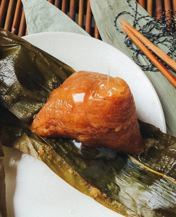 jiansui zongzi on a plate with syrup  by thewoksoflife.com