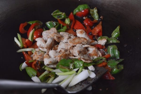 Adding chicken to stir-fry, by thewoksoflife.com