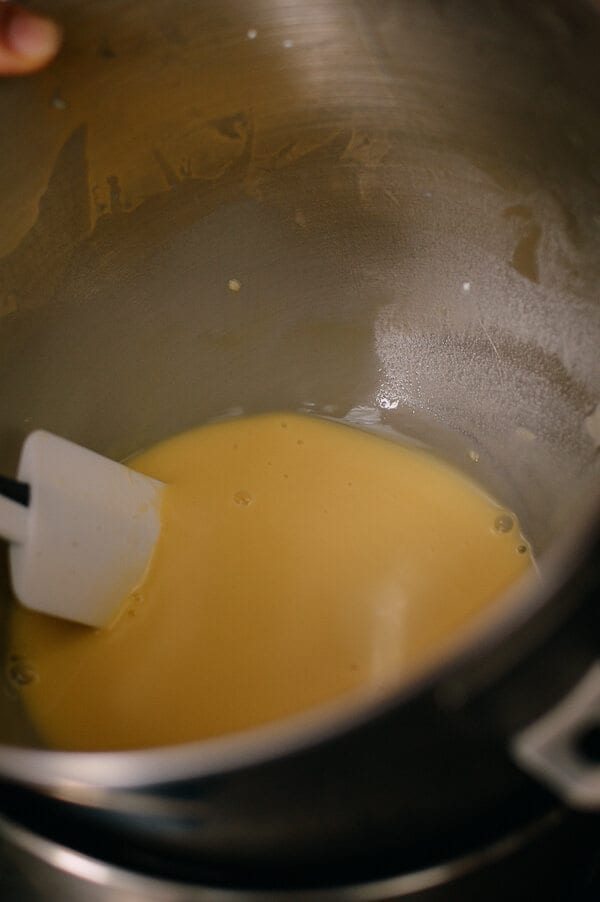 stirring custard over hot water for Cantonese Steamed Custard Buns, by thewoksoflife.com