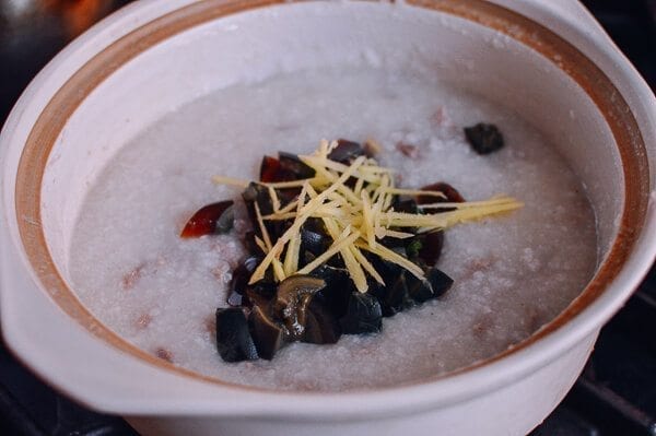 Adding ginger and thousand year old egg to congee, by thewoksoflife.com