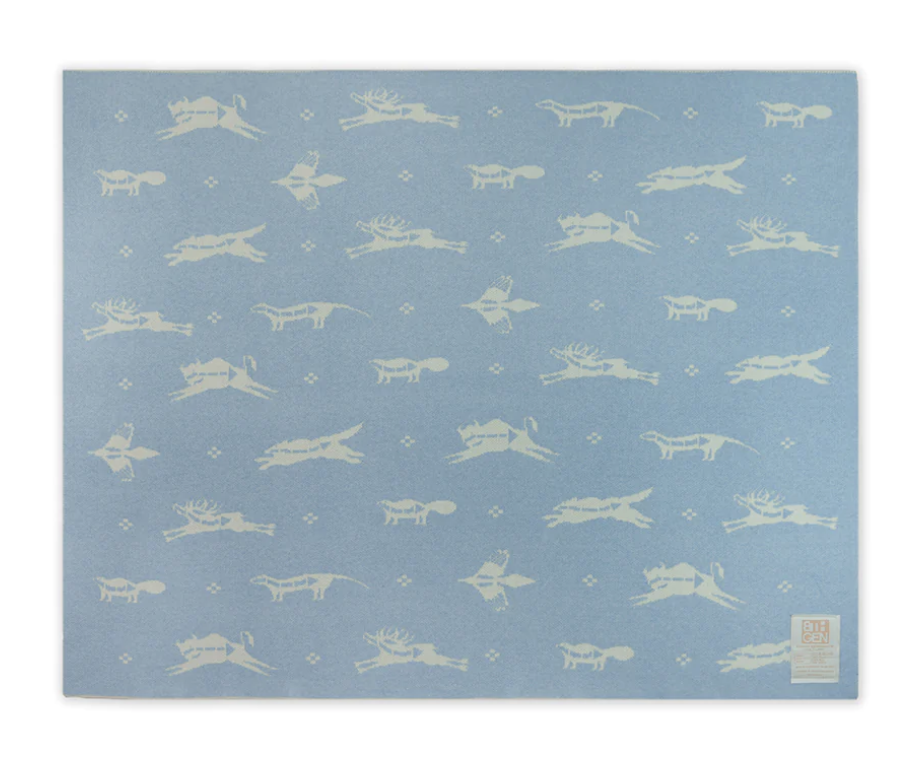 light blue baby blanket with Native American patterns in cream 