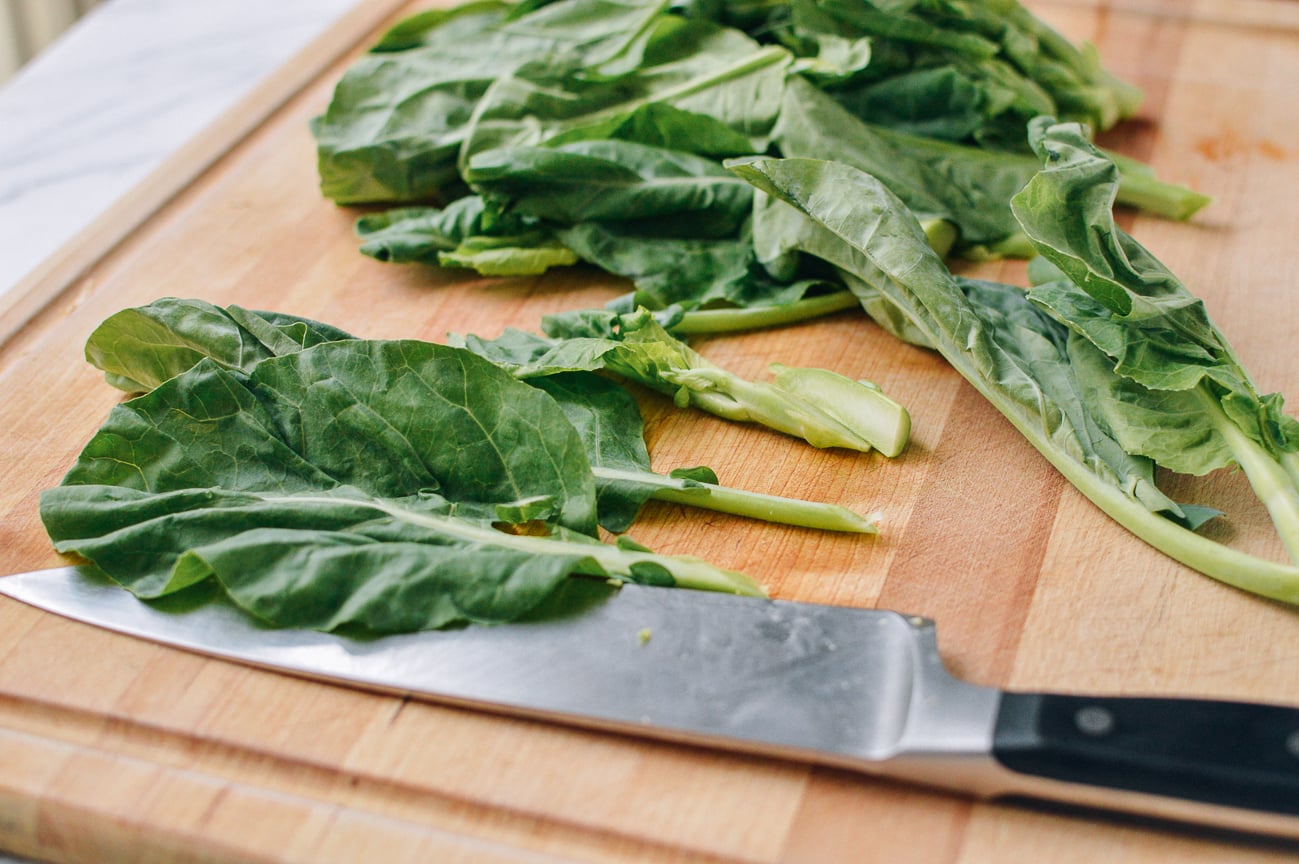 Cutting Chinese broccoli on cutting board