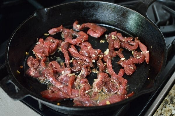 cooking flank steak in cast iron pan, thewoksoflife.com