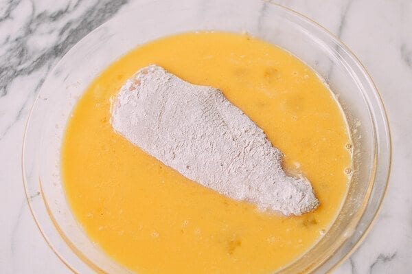 Dredged chicken breast in egg, by thewoksoflife.com