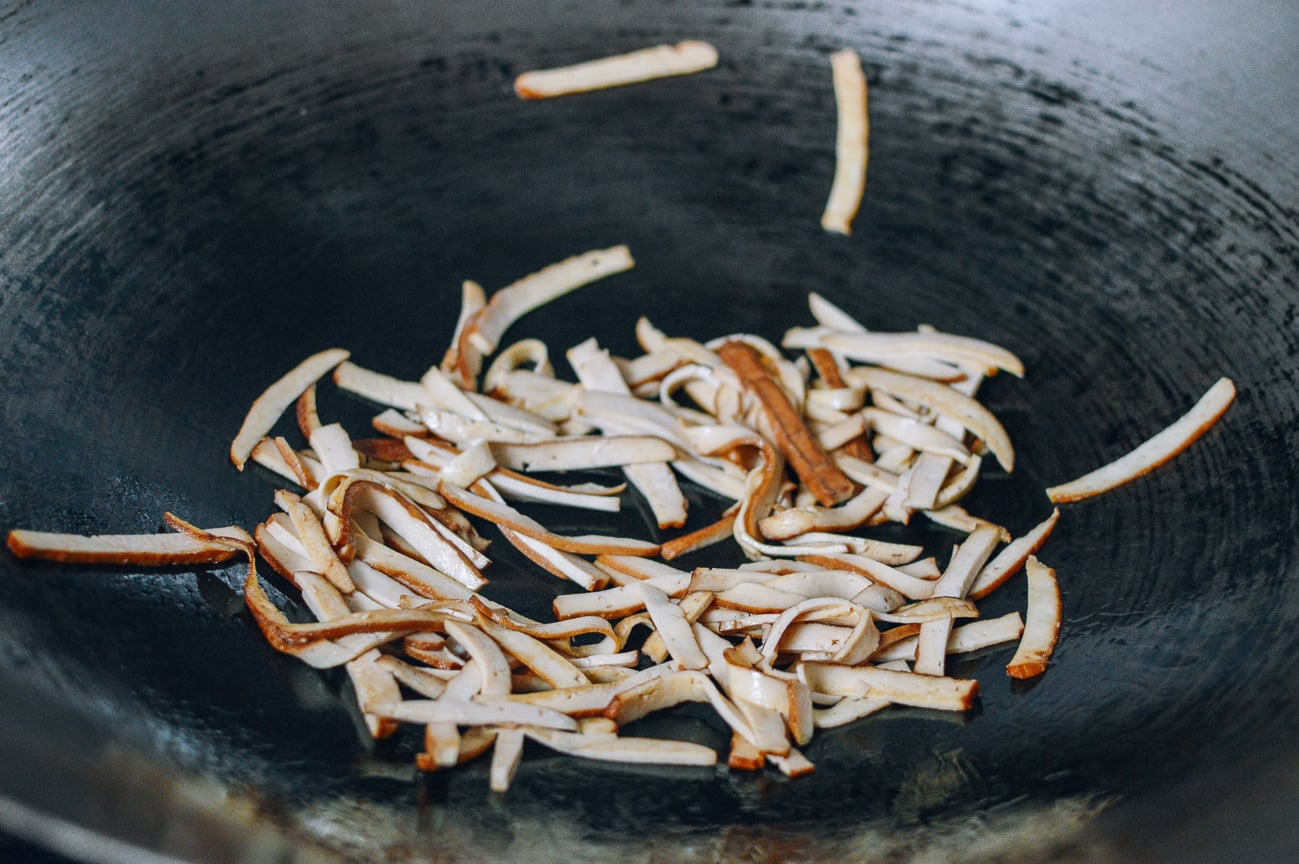 stir-frying tofu in wok