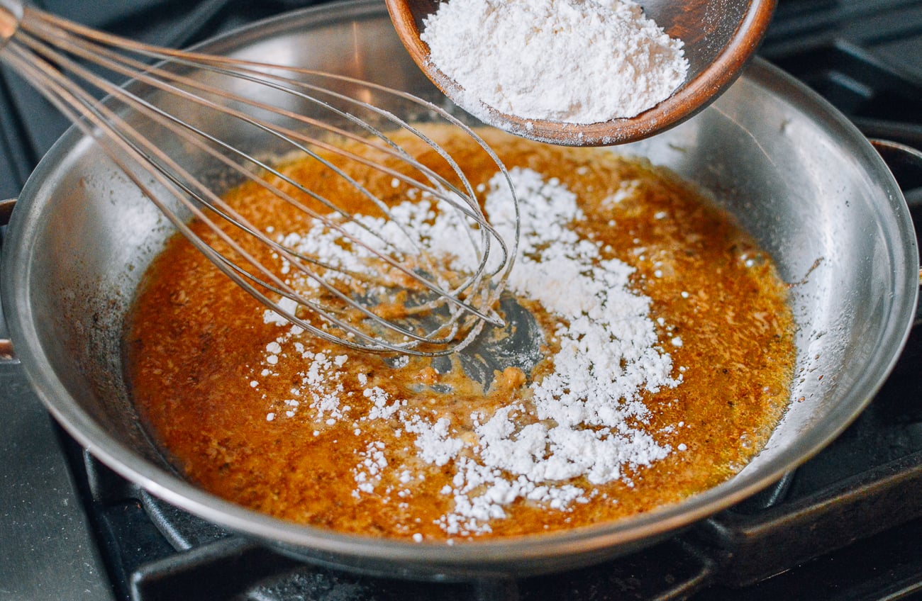 whisking flour into fat to make roux