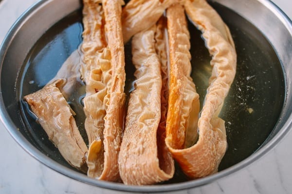 dried bean threads soaking in metal bowl of water