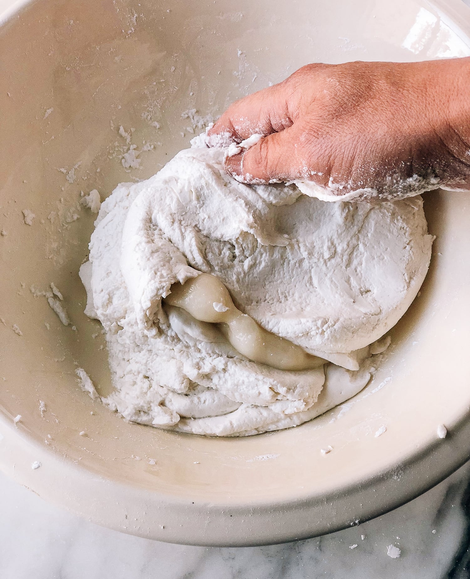 mixing cooked and raw rice flour dough in bowl, by thewoksoflife.com
