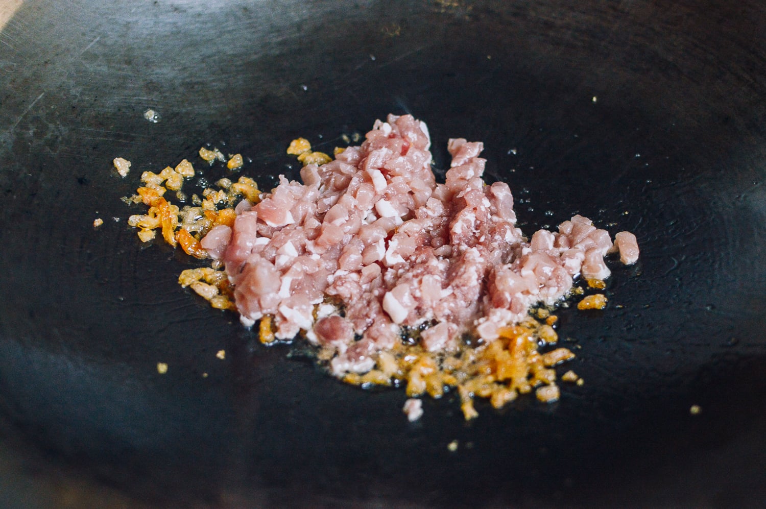 dried shrimp and pork cooking in wok, by thewoksoflife.com