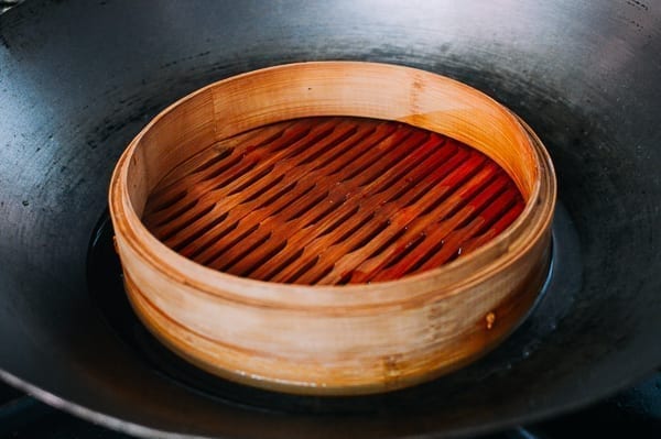Bamboo Steamer Base in Wok with Water, by thewoksoflife.com