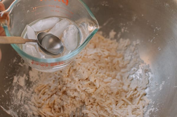 adding ice water to Rough Puff Pastry, by thewoksoflife.com