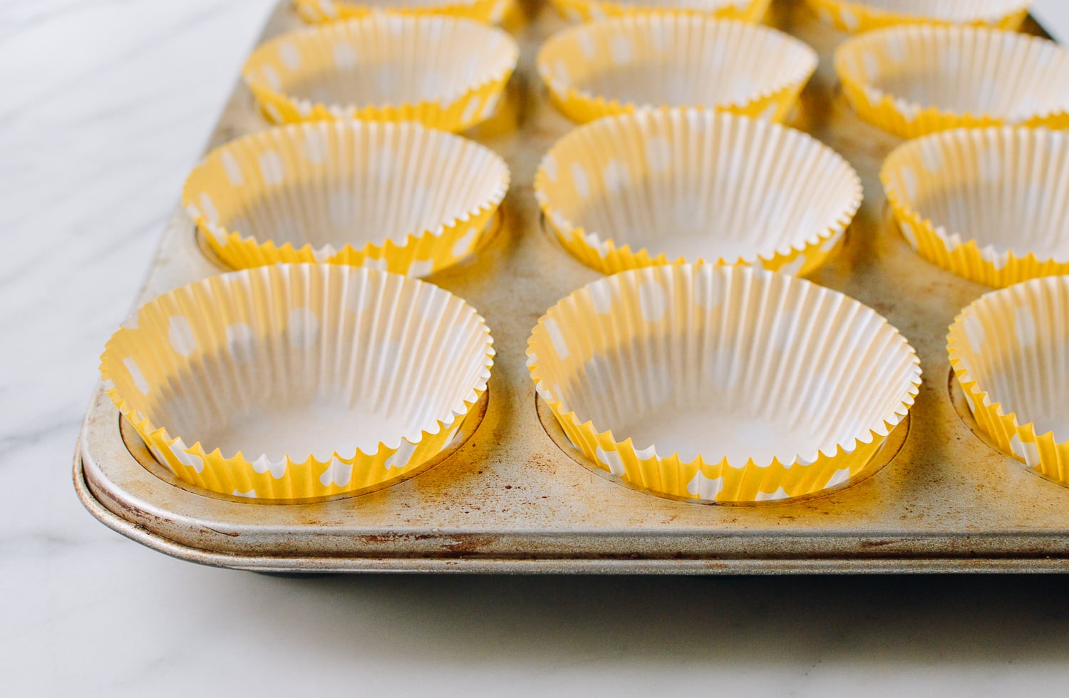 Muffin tin lined with paper cups, thewoksoflife.com