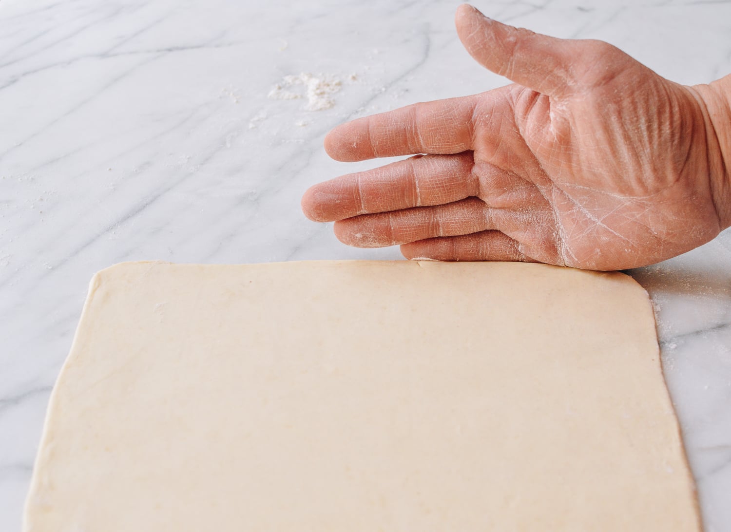 Using hands to straighten pastry edges, thewoksoflife.com